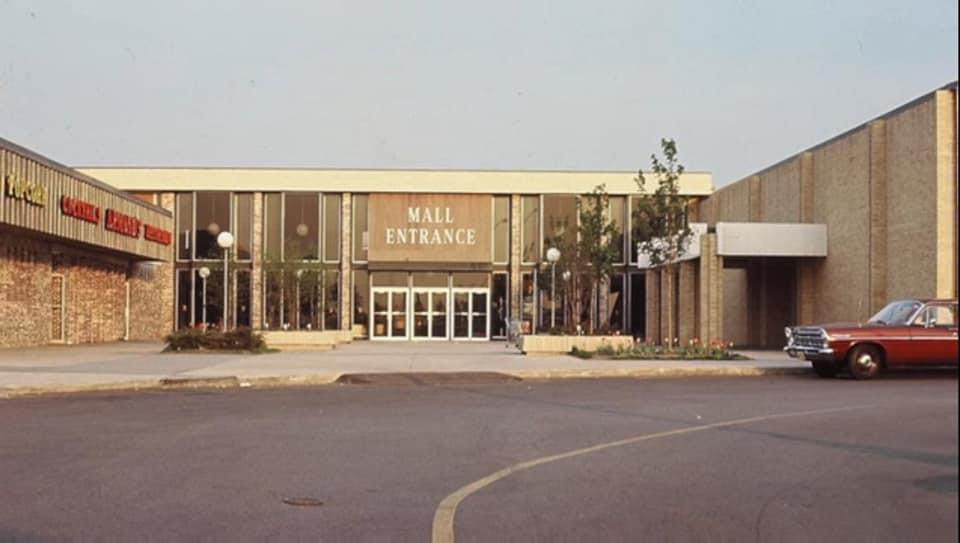 Vintage shopping mall entrance with empty parking lot