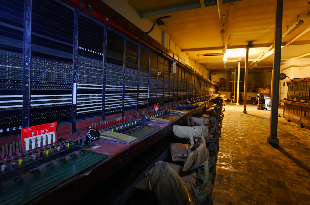 Abandoned switchboard room with rows of operators’ desks