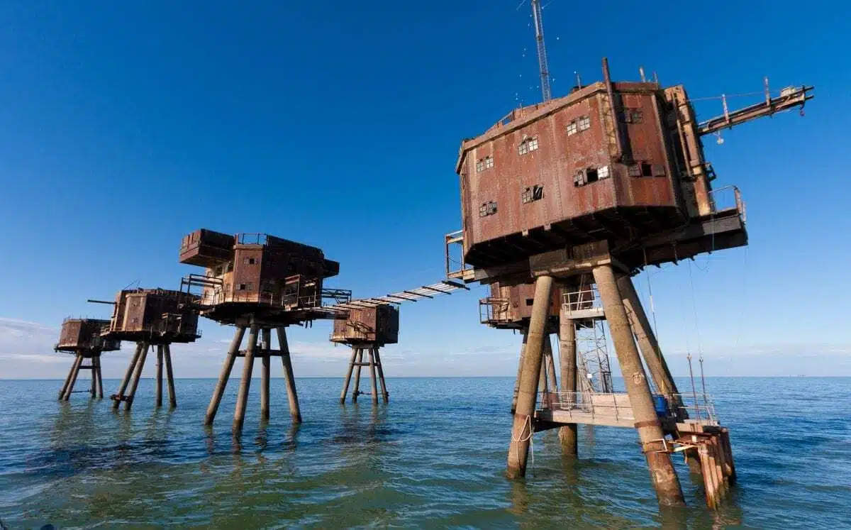Rusty sea forts on stilts in open water