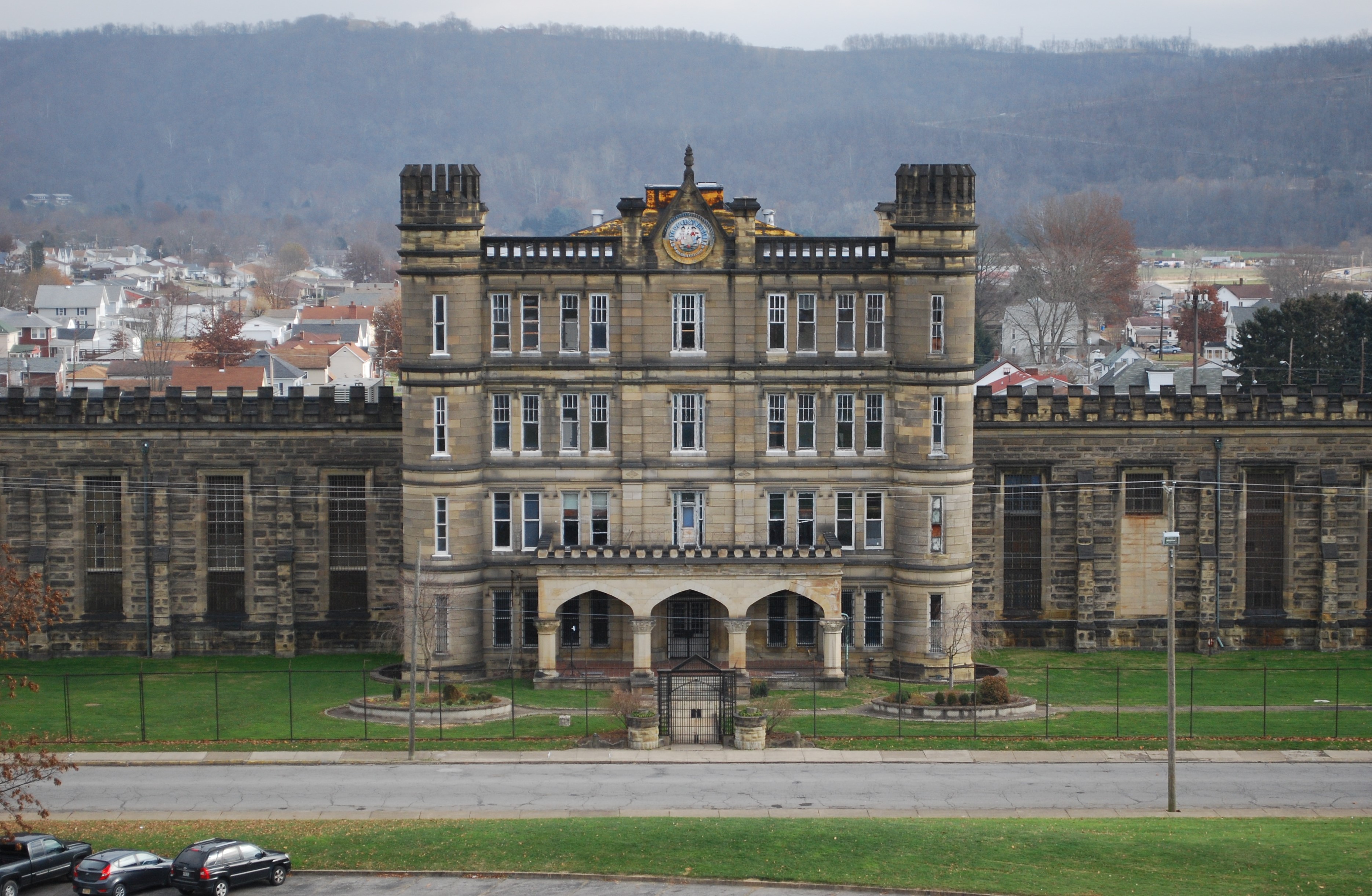 Stone penitentiary facade with arched entrance and towers