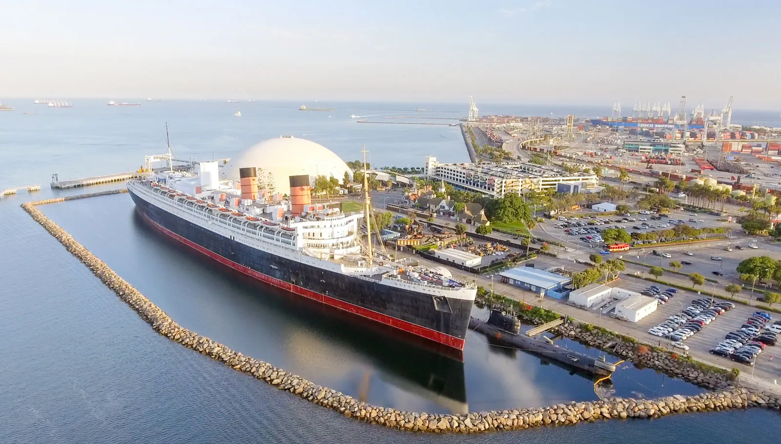 Ocean liner docked in harbor beside busy port